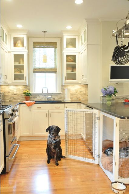 a neutral kitchen with shaker cabinets, black countertops, a built-in dog crate in the lower part is a cool space