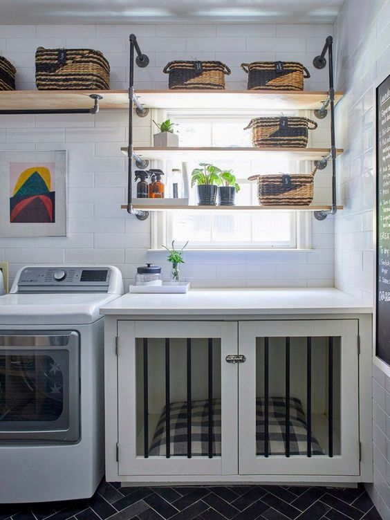 A simple white laundry with a built in dog crate, white appliances and suspended shelves for an industrial touch