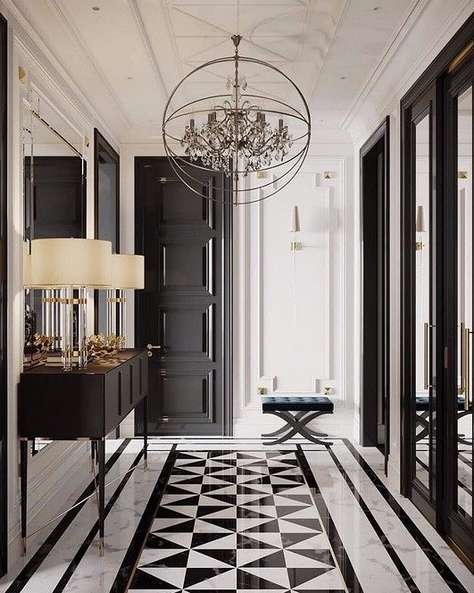 a small and sophisticated black and white foyer with a checked floor, a black door, a leather stool, a chic console table and a unique sphere chandelier