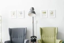 a stylish space wiht a grey and green Strandmon chair, a side table with a phone and a grey lamp, a mini gallery wall