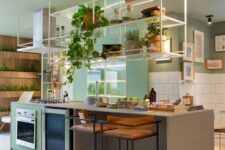 02 a bright modern kitchen with green walls, white square tiles, a kitchen island and a cabinet, a suspended shelf over it