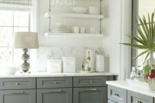 06 a grey and white farmhouse kitchen with shaker cabinets and white suspended shelves, a white marble backsplash and countertops