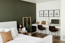 08 a lovely and functional bedroom with an olive green accent wall, a white bed with bedding, built-in desk, black chairs and a gallery wall