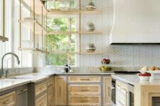 09 a light-stained farmhouse kitchen with shaker cabinets, a large hood, suspended shelves and a kitchen island