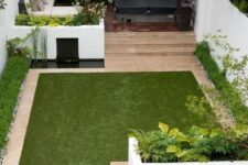 11 a minimalist townhouse garden with white flower beds with greenery, a tiny pond, a manicured lawn, a sectional sofa and a hot tub