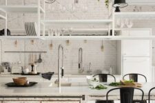 18 a white kitchen with modern cabinets and a shabby chic kitchen island, suspended shelves, black metal chairs