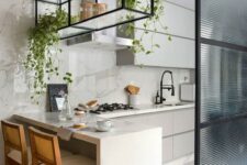 21 a beautiful contemporary kitchen in neutrals, with grey cabinets, a white marble backsplash and countertops, a suspended shelf over the island