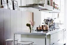 34 a modern creamy kitchen with suspended shelves over it, a metal countertop and white stools is a cool and chic space