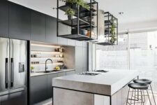 35 a modern industrial kitchen in black, with built-in shelves, a concrete kitchen island, suspended shelves over it and black stools