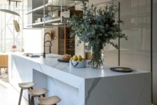 38 a sophisticated minimalist kitchen with a sleek grey storage unit, a white marble kitchen island, a suspended shelf