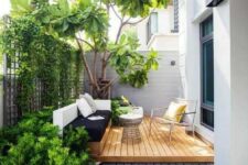 55 a small contemporary backyard with a wooden deck, a built-in daybed and a cool chair, some growing plants and a large living tree