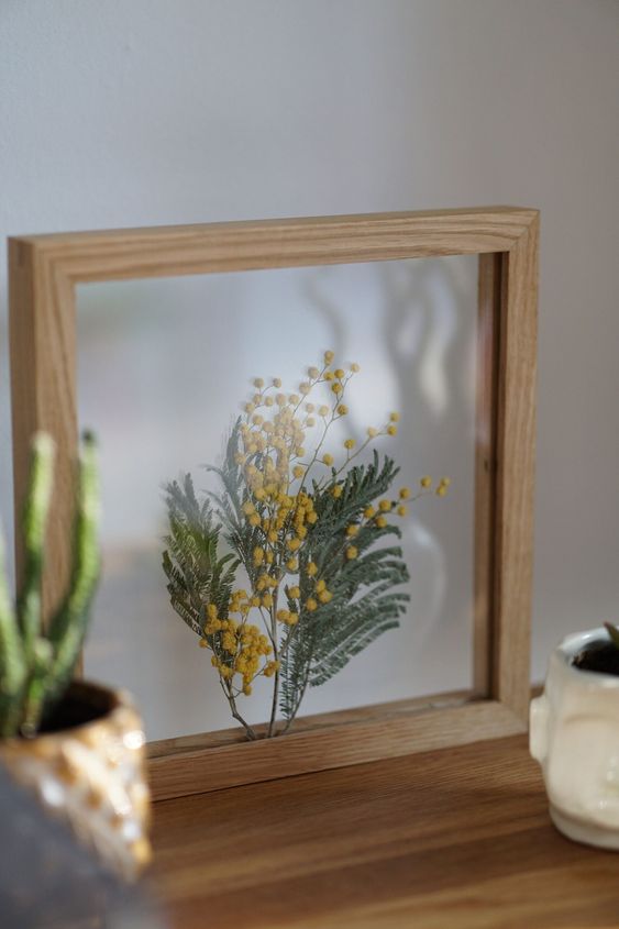 a bit of pressed leaves and berries in a light-stained frame will be a nice summer or fall decoration for your space