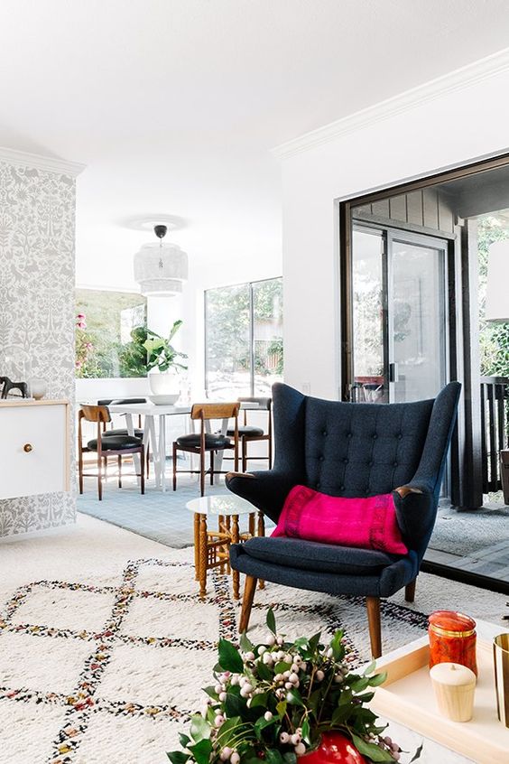 a bold space with a graphite grey Papa Bear chair and a fuchsia pillow, a side table and a potted plant is cool