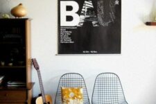 a cool modern space with a stained storage unit, black Eames wire chairs, some decor and artwork is a stylish nook