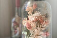 a large jar with pink and white dried blooms is a lovely decoration for a rustic or boho space, it looks airy and very chic