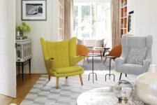 a neutral living room with a grey daybed, a coffee table, a grey chair and a yellow Papa Bear chair is cool