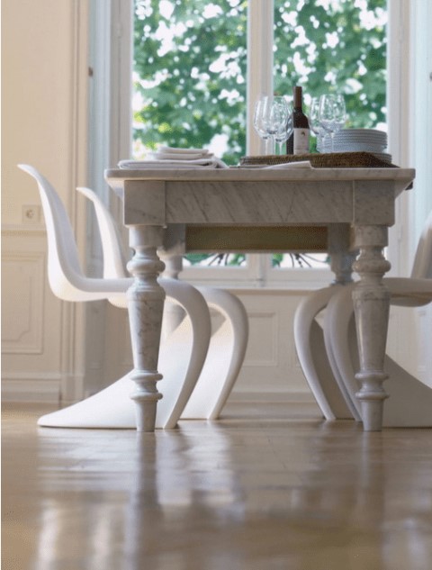 a refined dining table and white sculptural Panton chairs of the same shade to make the look not so different