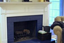 24 a colorful space with a navy brick fireplace and a white mantel, a colorful rug and some mantel decor