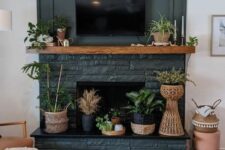 26 a cool non-working graphite grey fireplace with potted plants all over is a perfect fit for a boho space, and plants are a cool alternative to fire