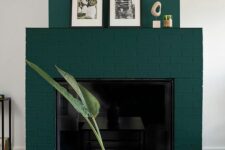 28 a forest green brick fireplace with some decor on the mantel, a black coffee table and a cool coral vase with leaves