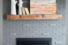 32 a grey brick fireplace with a stained mantel, some decor and a basket with a mantel is a stylish solution to rock