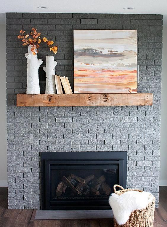 a grey brick fireplace with a stained mantel, some decor and a basket with a mantel is a stylish solution to rock