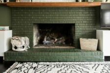 35 a lovely green brick fireplace with a stained mantel and lovely decor, a printed rug is a cool and cozy boho space