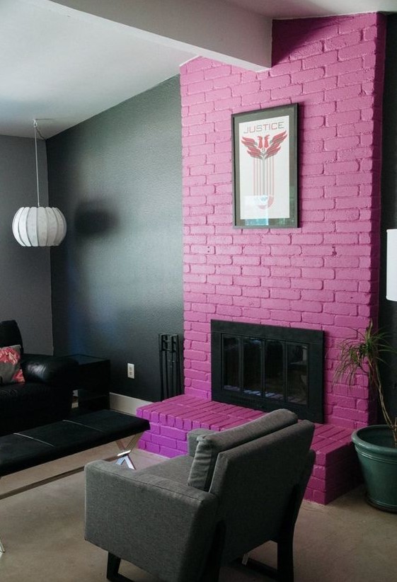 a moody living room accented with a purple brick fireplace and an artwork for a gorgeous statement