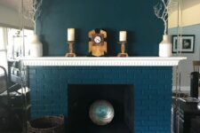 43 a teal brick fireplace with a chic mantel and some decor, with branches in vases and a basket is a bold and cool decoration