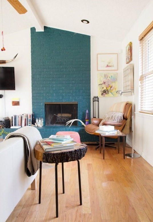 a teal brick fireplace, even a non-working one, is a very non-traditional decor feature to go for