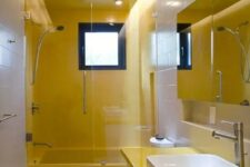 a contemporary neutral and yellow bathoom with pretty square tiles, a yellow and white vanity, a window that gives light and a lit up ceiling