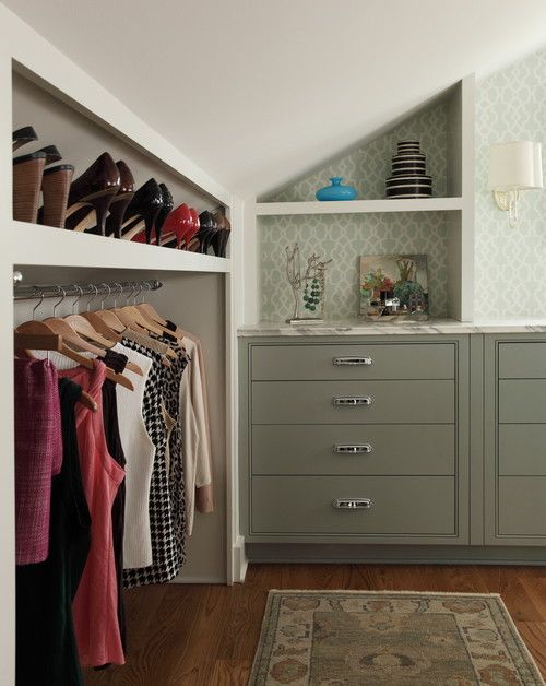 A cool and stylish attic closet with a built in shoe shelf and railing for clothes right in the sloped part of the room