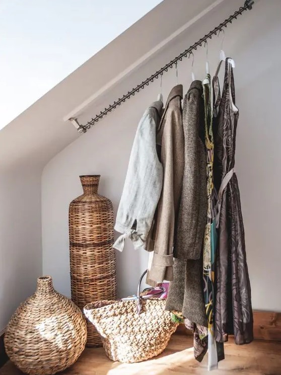 a cool attic storage idea - railing for clothes that makes your outfits part of your home decor or just saves space in the closet