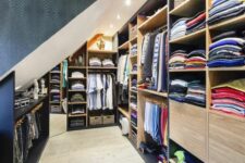 a large attic closet with open storage compartments and rails, built-in storage units is a very smart and cool idea