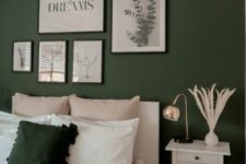 a lovely modern bedroom with a dark green accent wall, a white bed and neutral bedding, a gallery wall, a white nightstand