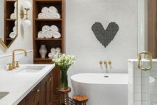 a modern bathroom with penny and printed tiles, a stained vanity and cabinets, a tub and a burst chandelier
