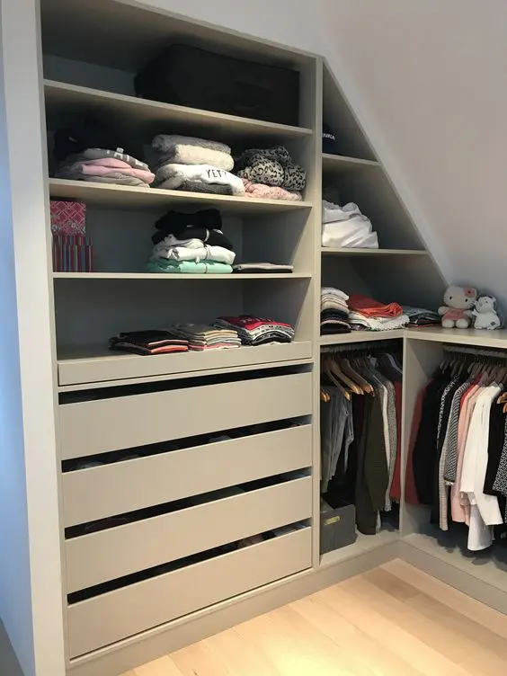 a small attic closet with open storage compartments, drawers and rails for clothes is a cool idea if you don't have much space for a closet