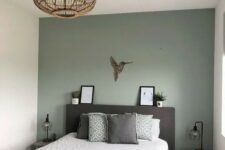 a modern small bedroom design with a calm green accent wall