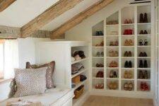 a small yet cozy attic space with a windowsill daybed and built-in shoe shelves and clothes shelves is a very cool idea