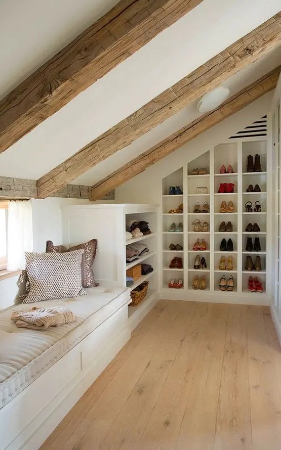 A small yet cozy attic space with a windowsill daybed and built in shoe shelves and clothes shelves is a very cool idea