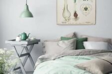 pastel green bedding and a pendant lamp for bringing freshness to the space