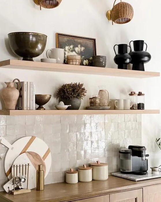 A beautiful neutral kitchen with neutral zellige tiles, light stained shelves and cabinets is a chic and catchy idea