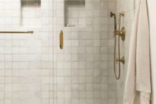 08 a lovely shower space clad with neutral zellige tiles and marble ones, with chic brass features for a touch of vintage in the space
