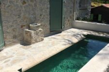 14 a small and rustic backyard done with stone and a narrow and long pool that will refresh you