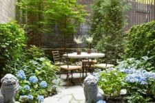 17 a small side yard with trees, greenery, blue blooms, a contemporary dining set and Asian decor
