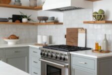 19 a modern farmhouse kitchen with grey shaker cabinets, white stone countertops, a zellige tile backsplash, open shelves