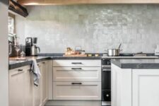 20 a modern farmhouse kitchen with neutral shaker cabinets, black stone countertops, a pale green zellige tile backsplash