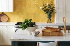 24 a neutral farmhouse kitchen with planked cabinets, a dark green planked kitchen island and a yellow zellige tile backsplash