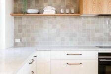 25 a neutral modern kitchen with fluted cabinets, a zellige tile backsplash, open shelves and a wood clad hood