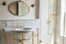 26 an elegant neutral bathroom accented with neutral zellige tiles, with a free-standing sink and gold fixtures